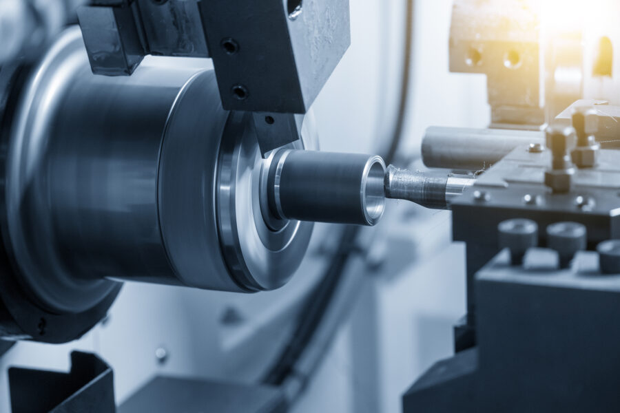 The  CNC lathe machine bore cutting the metal shaft parts.